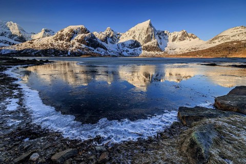 Sunrise, morning light, steep mountains and fjord, ice, winter, Flakstadoya, Lofoten, Norway,