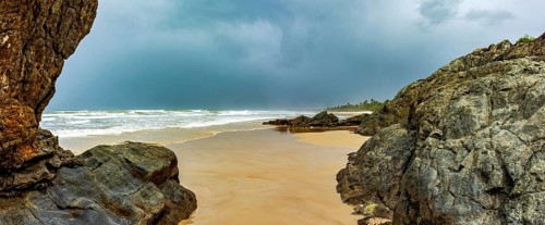 Dark rain clouds over Pe de Serra beach in Serra Grande on the southern coast of Bahia