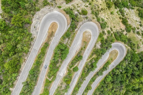 Aerial view, drone shot, Mountain pass road with multiple hairpins, water pipeline, Switzerland,