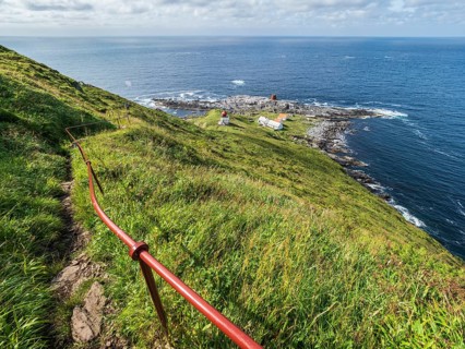 Lighthouse at the coast of island Runde, path to the lighthouse, Norway, Europe