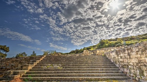 Stone staircase in an ancient ruin under a sunny sky with clouds, historical site, Kamiros,