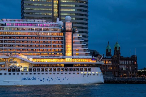 Cruise ship Aida Prima at the Cruise Terminal of Rotterdam, Kop van Zuid, skyscrapers at the
