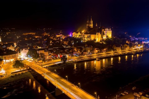 City view at night with Albrechtsburg castle, cathedral, old town, Elbe river and old Elbe bridge
