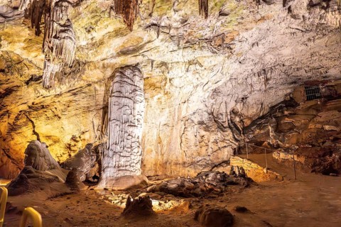 Stalagmites and stalactites creating a brilliant column inside postojna cave, a famous tourist
