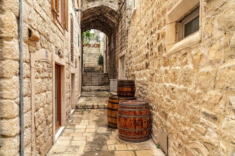 Barrels in a narrow alley in the old town of Korcula, Croatia, Europe
