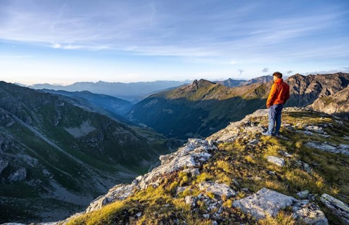 Mountaineer at the summit of Mont de la Blana, mountain landscape at sunset, view over the valley