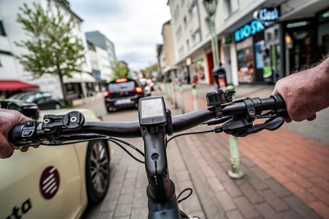 Cycling in the city, inner-city street, cycle lane, bicycles have priority, two-lane traffic with