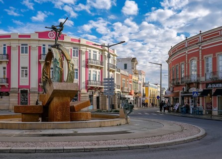 Loule, Algarve, Portugal - Houses with colourful facades in the old town of Loulé, roundabout with