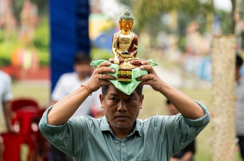 NAMSAI, INDIA.- APRIL 16: A devotees carries the idol of Lord Buddha as he celebrate the vibrant