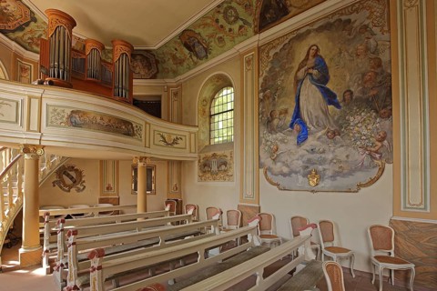 Idyllic small baroque castle chapel, interior view, organ with gallery, painting with Madonna