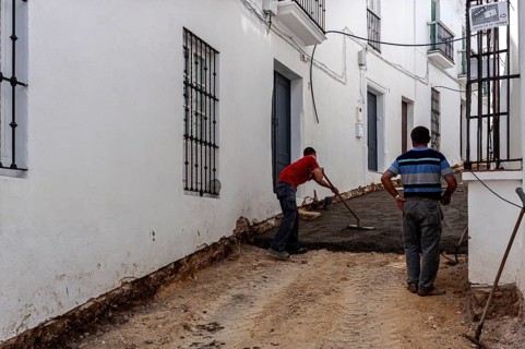 Construction workers renew asphalt surface in a small street, Vejer, Andalusia, Spain, Europe