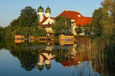 Romanesque Benedictine Abbey Seeon Monastery, monastery church St. Lambert with reflection in the