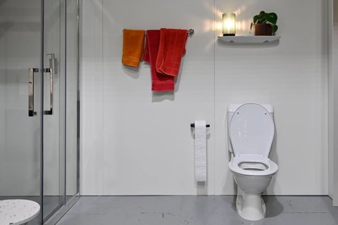 Toilet, shower door and bath towels