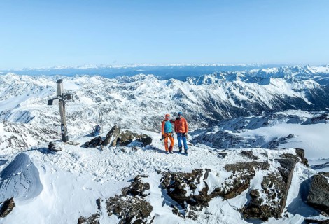 Two ski tourers on the summit of Cevedale, Alpine panorama, Aerial view, Snow-covered mountain