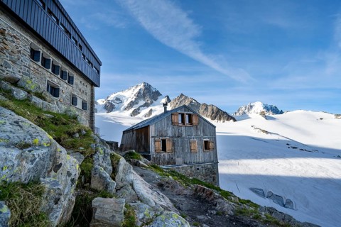 Old and new mountain hut Refuge Albert 1er, high alpine mountain landscape, summit of the Aiguille