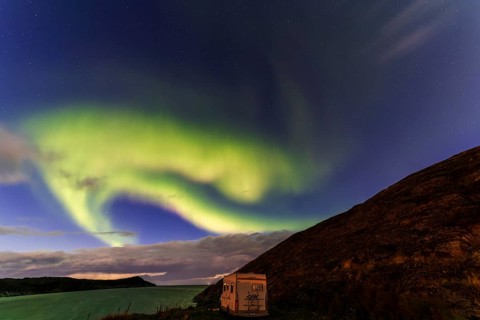 Northern Lights, (Aurora borealis) at a fjord in the Barents Sea near Bugoynes, September 2024,
