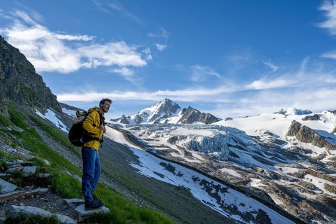 Mountaineer in front of high alpine mountain landscape, summit of the Aiguille de Chardonnet and