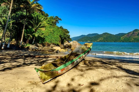 Fishing canoe over beach sandof Castelhanos beach in Ilhabela, Castelhanos beach, Ilhabela, Sao