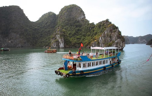 Excursion boat and the karst rocks in Lan Ha Bay, Halong Bay, Vietnam, Asia