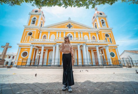 Portrait of a beautiful tourist girl in front of the cathedral in Granada, Nicaragua. Portrait of