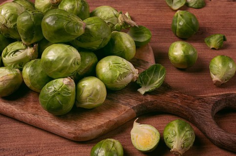 Fresh Brussels sprouts, raw, top view, on a wooden table, no people
