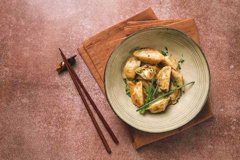 Japanese fried gyoza dumplings, with pork, sesame seeds, green onions