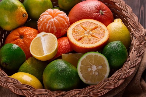 Assortment, citrus fruits, in a basket, close-up, top view, no people