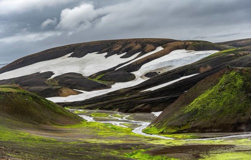 Colourful volcanic landscape with hills and snow, volcanic hot springs, Laugavegur trekking trail,