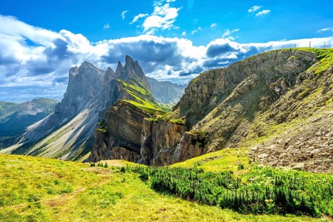 Majestic peaks of seceda mountain glowing under the summer sun in val di funes, dolomites, italy