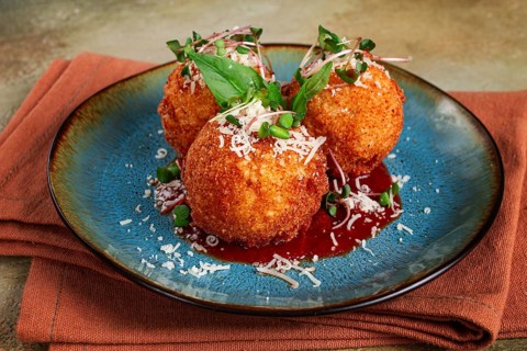 Crispy Arancini appetizer, with parmesan cheese and microgreens, plate, tomato sauce, homemade, no