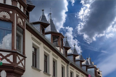 Roof bay with pointed spires on a historic inn, built in 1838, Weingasse 1, Bad Kissingen, Lower