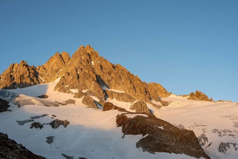 Rocky mountain peak, summit of the Aiguille de Tour in the evening light at sunset, Chamonix,