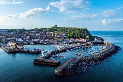 Scarborough Lighthouse and Harbour from a drone, Vincent Pier, Scarborough, North Yorkshire,