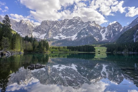 The Mangart mountain range reflected in Lake Fusine, Tarvisio, province of Udine, Italy, Europe