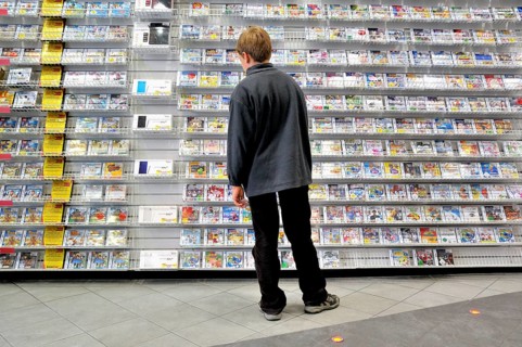 Ten-year-old boy in a shop with a surplus of Nintendo DS games, Germany, Europe