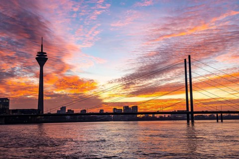 Winter sunset on the Rhine near Düsseldorf, Rhine Tower, cargo ship, Rhine knee bridge, North