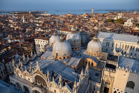 View over the roofs of Venice with St Mark's Basilica and Doge's Palace in the evening light, view