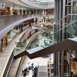 Stilwerk Düsseldorf, free-floating staircase in the elliptical atrium with surrounding galleries on