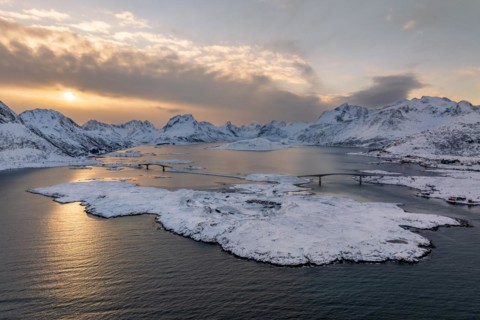 Snowy mountains by the fjord, bridges over fjord near Fredvang, Lofoten, Norway, Europe