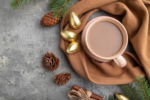 Christmas or New Year composition. Decorations, cones, cinnamon, fir and spruce branches, cup of