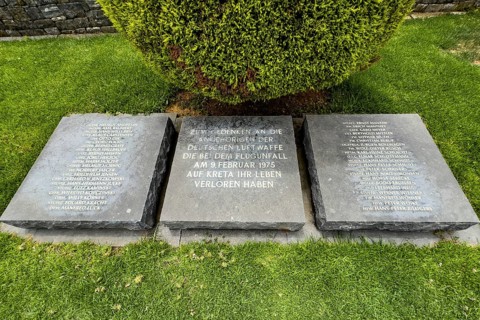 Three memorial plaques at the Maleme military cemetery with the names of the crew of a plane that