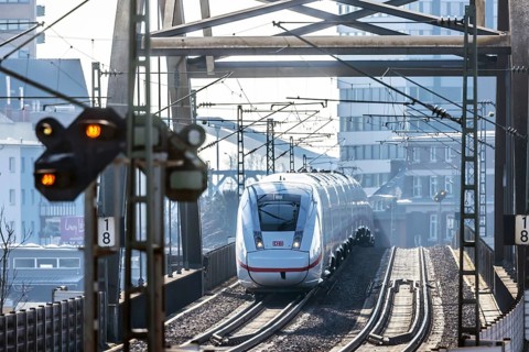 ICE en route on a railway bridge with tracks and signalling system. Mannheim, Baden-Württemberg,