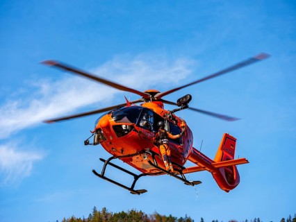 On-board mechanic of the rescue helicopter Christoph 14 winching with the cable winch, Bad