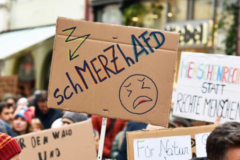 Heidelberg, Germany - February 12th 2025: Person holding up sign about CDU politian Merz and right