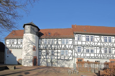 Small castle built in 1564, historic half-timbered house with oriel and turret, Rückingen,
