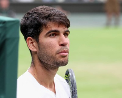 Spanish tennis player Carlos Alcaraz looking at his coach on the centre court at the 2024 Wimbledon