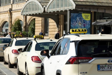 Taxis parked at a taxi rank in front of Dammtor train station in Hamburg, Germany, Europe