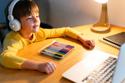 High view child taking virtual courses