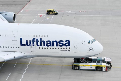 Lufthansa Airbus A380-800 being towed with push back truck on taxiway towards Lufthansa maintenance