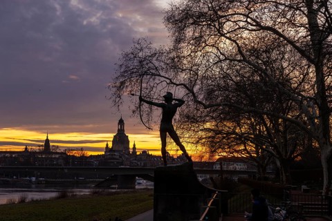 Sunset on the banks of the Elbe in Dresden, with a view of the historic old town and the archer,
